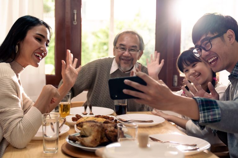 A Multigenerational Family Sitting Around The Dinner Table.